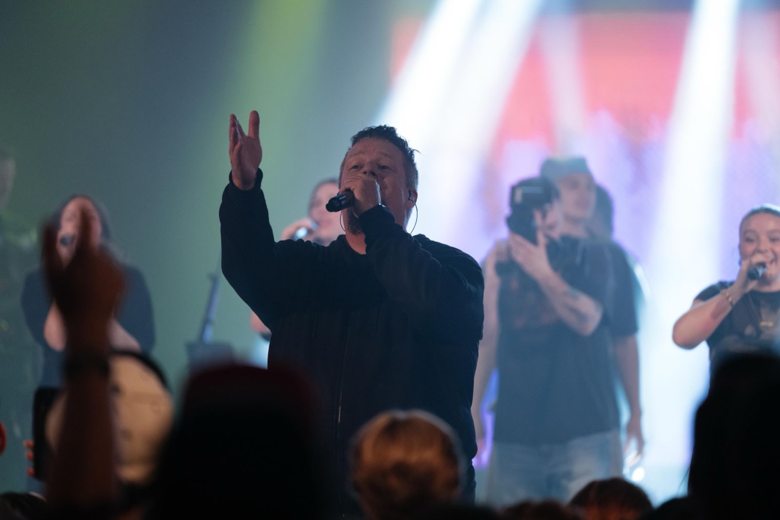 Worship leader with hand raised