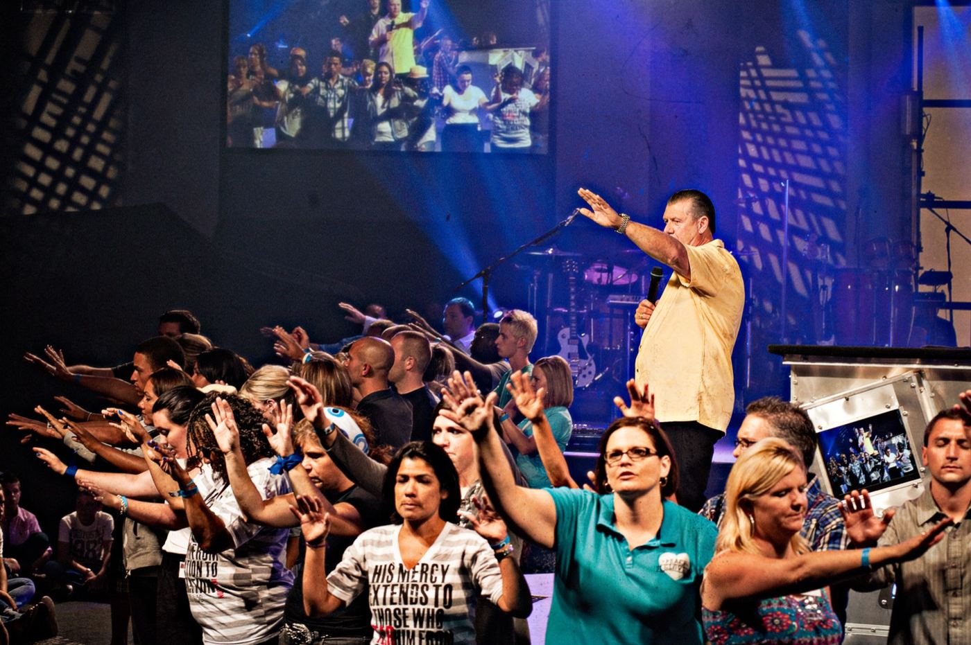 Hands reaching toward the stage in 2010