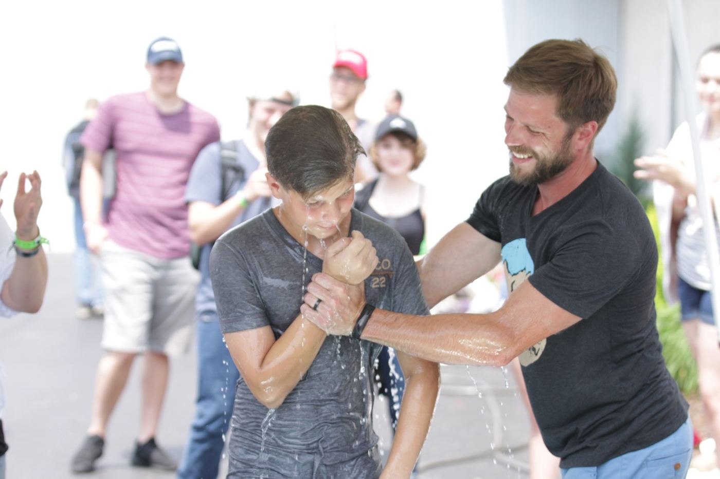 A leader praying with a student